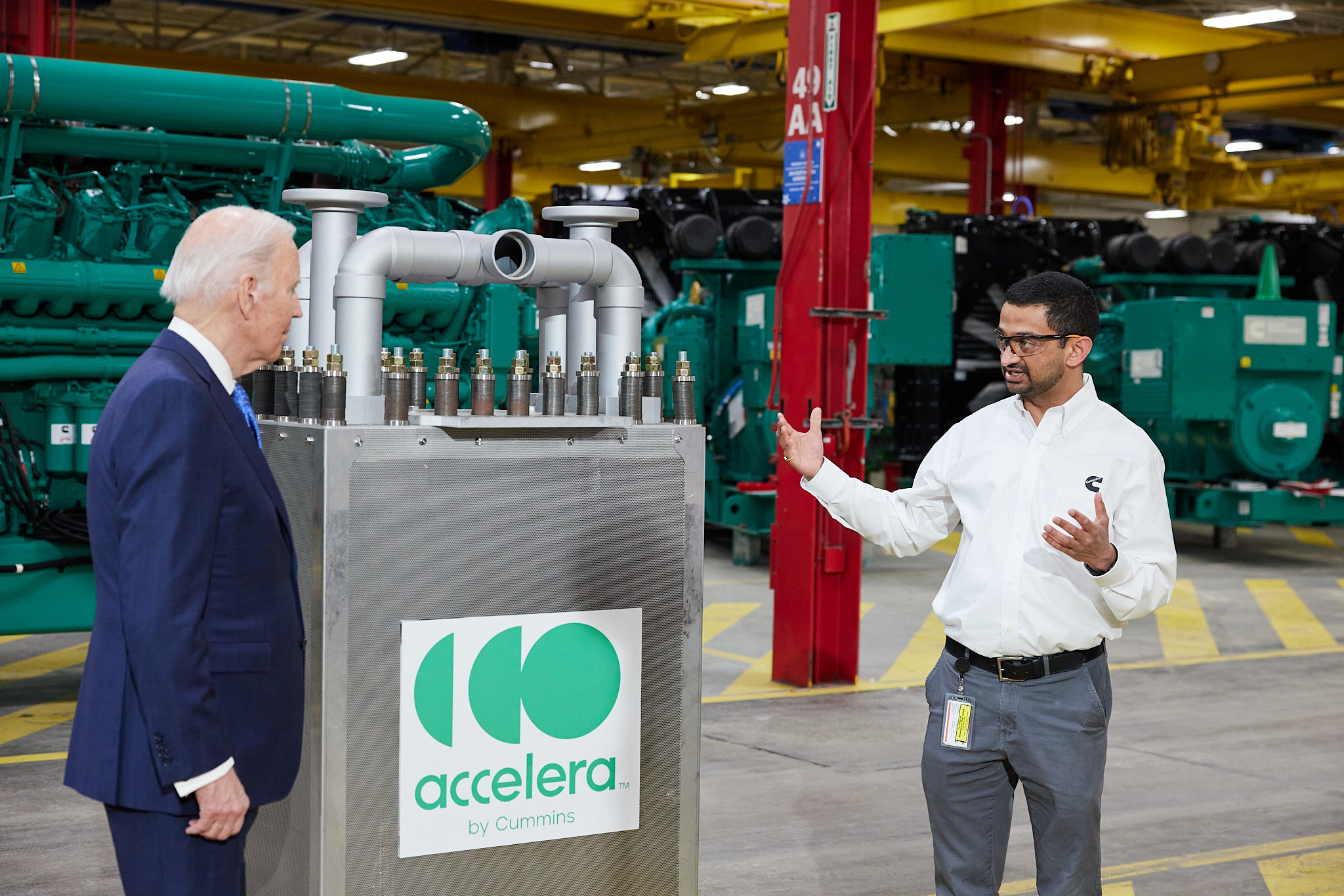 POTUS standing by an Accelera electrolyzer stack and conversing with an employee