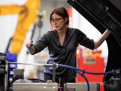 female technician inspects vehicle