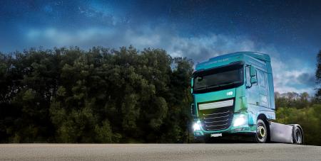 European zero-emissions truck at night with headlights on